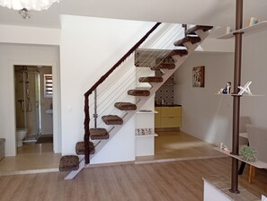 A staircase with a unique design, leading to a bathroom and a kitchen area. - Stunning 100m² Modern Townhouse with Sea Views & Private Garden (Ližnjan)