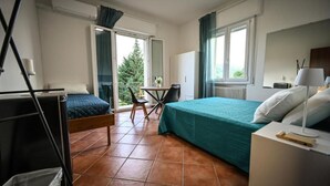 A bedroom with a bed, a desk, a chair, and a window. - Vrbo Property (Savigno)