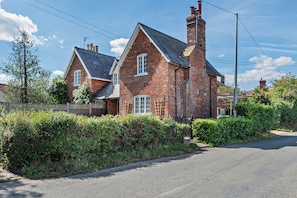 A two-story brick house with a gabled roof and a chimney. - Host & Stay | Lavender Cottage SLEA (Pointon)