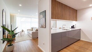 A modern apartment with a kitchen, living area, and a large window. - Polacos Residence | 2BR | Apt I by LovelyStay (Vila Nova de Gaia)