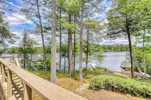 A wooden deck overlooking a lake surrounded by trees. - Unique 4BR Lakefront Adirondacks - Dock (Chestertown)