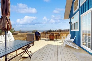 A wooden deck with outdoor furniture, a barbecue grill, and a view of the landscape. - 1BR vineyard stay with firepit, grill, & EVC (Keuka Park)