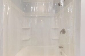 A bathroom with a bathtub, a shower, and a toilet. - Walk to Canandaigua Spots, Wine Trail, Lakes (Canandaigua)