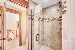 A glass-enclosed shower with a tiled wall and a wooden door frame. - Luxe 4BR Mountainview Adirondacks (North Creek)