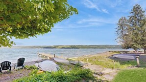 A lakeside outdoor seating area with chairs, a table, and a covered picnic table. - Gorgeous, dog-friendly 6BR with amazing views (Rock Stream)