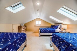 A bedroom with two beds, a desk, and a window. - Keuka Vista|Lakefront 4BR with amazing views, dock & game room (Penn Yan)
