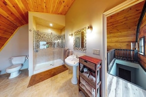 A bathroom with a shower, toilet, sink, and wooden ceiling. - Spacious Studio Lakeview Finger Lakes - Balcony (Burdett)