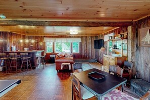 A rustic interior with a bar area, seating, and a fireplace. - 6BR country retreat with game room & large yard (Penn Yan)