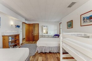 A bedroom with a bed, a wooden wardrobe, a bookshelf, a dresser, and a bunk bed. - Lakefront Retreat w/Private Dock & Cozy Deck Views (Penn Yan)