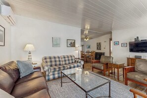 A living room with a sofa, armchairs, a coffee table, and a television. - Lakefront Retreat w/Private Dock & Cozy Deck Views (Penn Yan)