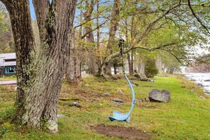 A park with a blue bench, trees, and a grassy area. - Classic 2BR Riverfront Adirondacks - Deck (Chestertown)