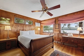 A wooden-paneled bedroom with a bed, a desk, and a chair. - Gorgeous 3BR Lakefront Adirondacks - Dock (Brant Lake)