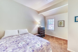 A bedroom with a bed, a dresser, a lamp, a window, and a framed picture on the wall. - Spacious 4BR with firepit & dock, nearby lake access (Chestertown)