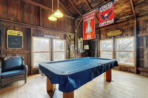 A pool table in a room with wooden walls and a banner for the Stanley Cup Champions 2018. - 1BR - loft withexpansive lake views, deck & grill (Dundee)