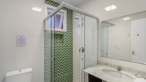 A bathroom with a shower, a toilet, a sink, and a mirror. - 2BR Duplex w/ Pool 350m From Sea Vle003 (Bombinhas)