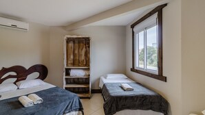 A bedroom with two beds, a wooden wardrobe, and a window. - 2BR Duplex w/ Pool 350m From Sea Vle003 (Bombinhas)