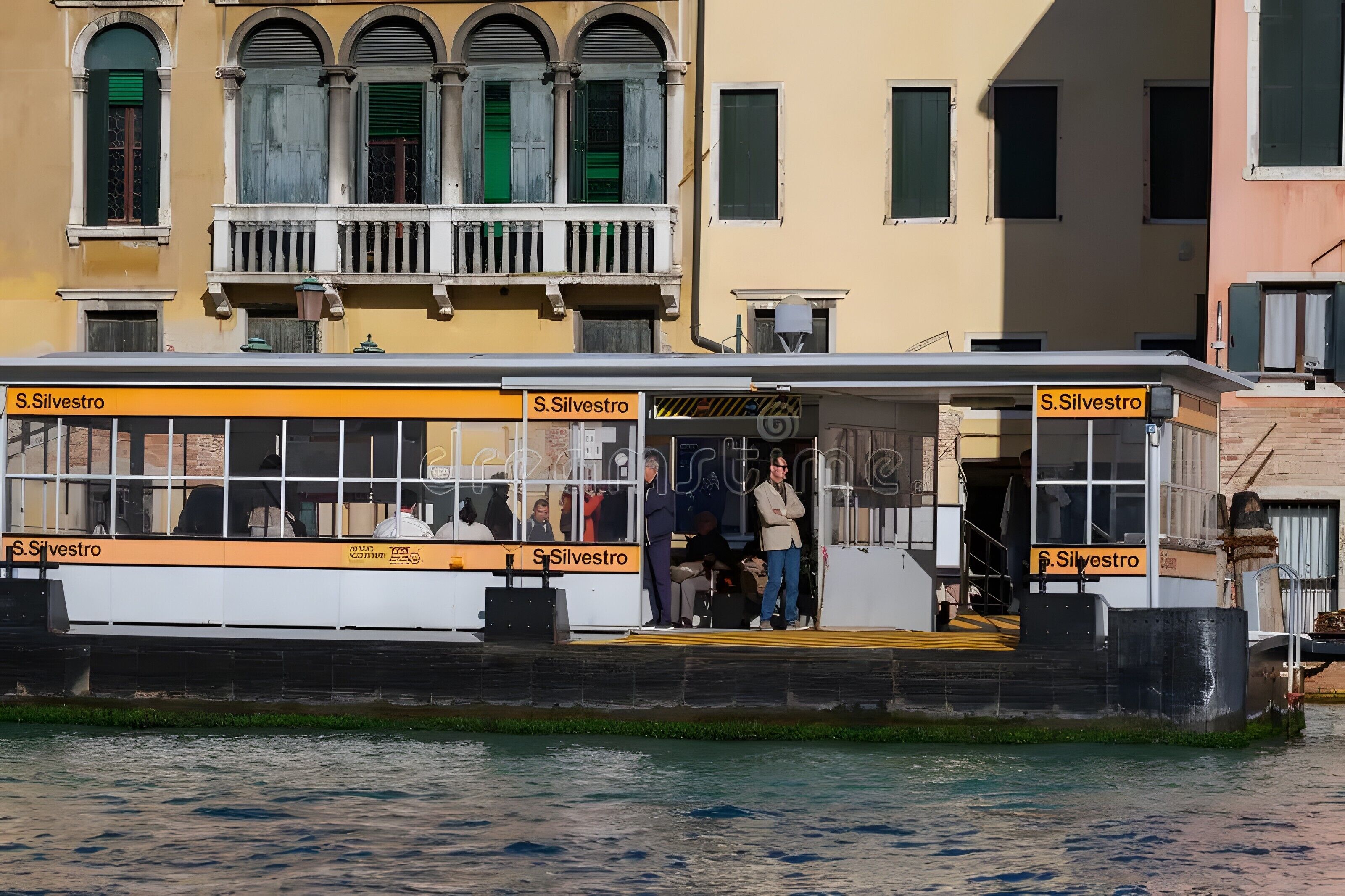 A ferry with 'S. Silvestro' signage, passengers, and a water body.