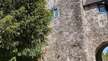 A stone building with a tower and arched entrance.