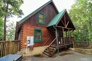 A wooden cabin with a porch and stairs leading to the entrance. - Mountain View Retreat 🏔️ Private Hot Tub, Arcade Room, Steps to Pigeon Forge Fun (Pigeon Forge)