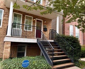A two-story brick building with a wooden staircase and a gated entrance. - Near downtown, Tremont, Ohio City, Rock Hall (Cleveland)