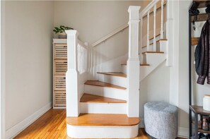 A staircase with white balusters and wooden steps leading to a landing.