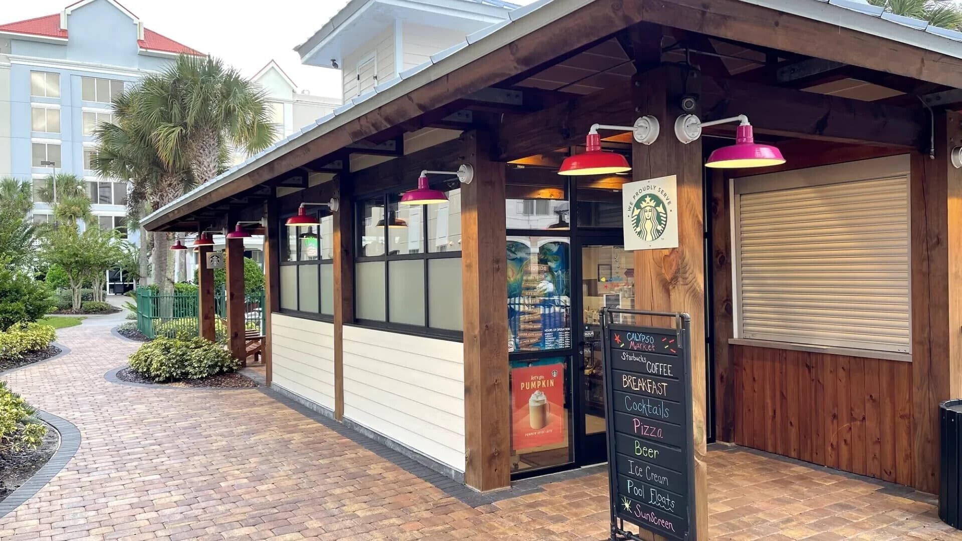 A storefront with a signboard listing breakfast options and a Starbucks logo.