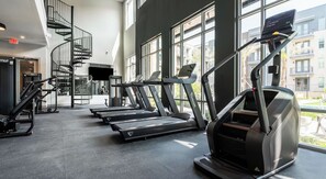 A gym with treadmills, a TV, and a staircase. - Cozy Studio Stay w/  Resort Amenities TNS 4210 (Austin)