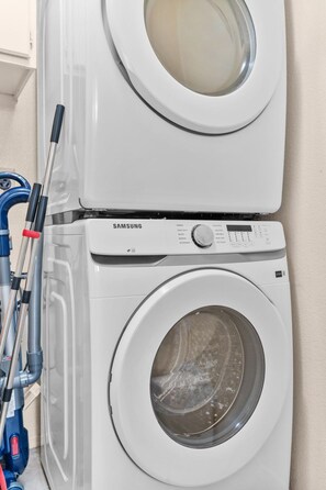 A Samsung front-loading washer and dryer stacked vertically. - 4BR San Diego Retreat | BBQ & Outdoor Living (San Diego)