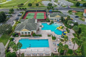 A residential property with a swimming pool, tennis courts, and a covered patio area. - Rosemont Retreat-5BR Private Pool Home Near Disney with Golf Resort Amenities (Davenport)