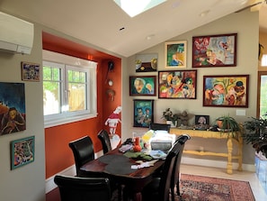 A dining area with a wooden table, chairs, and a window. - artist's home (Boulder)