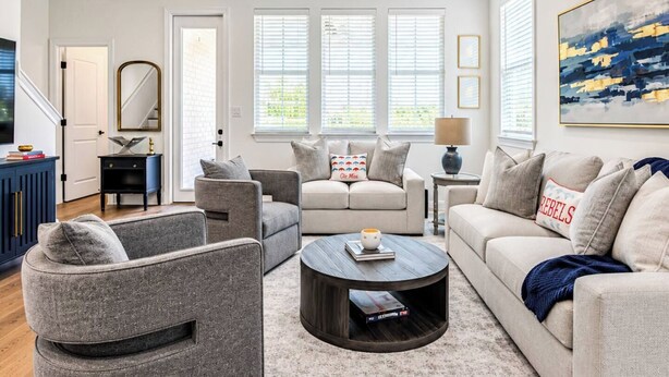 A living room with a grey sofa, a round coffee table, and a ceiling fan. - The Summit House, 3BR by Velvet Ditch Villas (Oxford)