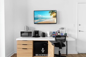 A kitchenette with a microwave, coffee maker, toaster, and kettle. - Beachwalk Elite Studio Resort Style - Bay View (Hallandale Beach)