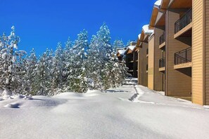 A snow-covered pathway leading to a building with multiple balconies. - Bend Adventure Starts Here - Near Mt Bachelor (Bend)