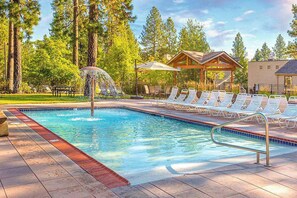 A swimming pool with a water feature, surrounded by lounge chairs and a gazebo. - Bend Adventure Starts Here - Near Mt Bachelor (Bend)