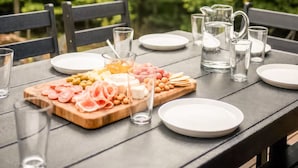 An outdoor dining table set with plates, glasses, and a variety of food items. - NEW-Casa Vetta 4BR Davis Cabin, Deck, Fire Pit (Davis)