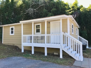 A two-story house with a front porch, a satellite dish, and a mailbox.
