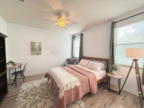 A bedroom with a bed, a desk, a chair, a floor lamp, and a ceiling fan. - Feel at Home in Stone Oak @great for Weeks/Months /3 beds 2.5 baths- Gated (San Antonio)