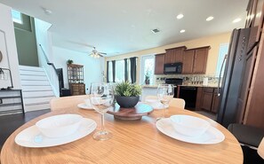 A dining area with a round table, white plates, and wine glasses. - Feel at Home in Stone Oak @great for Weeks/Months /3 beds 2.5 baths- Gated (San Antonio)