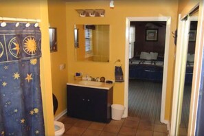 A bathroom with a sink, mirror, and shower curtain. - Big Cottage, sleeps 21 close to Lake Ouachita! (Mount Ida)