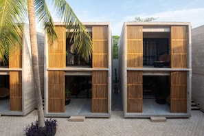 A modern building with two-story structures, each with a balcony and a wooden slatted facade.