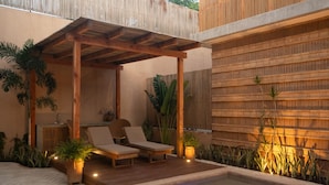 A covered outdoor seating area with two lounge chairs, a small table, and a hot tub. - Jilöo - Beautiful Oasis in Punta Zicatela (3) (Punta ZIcatela)