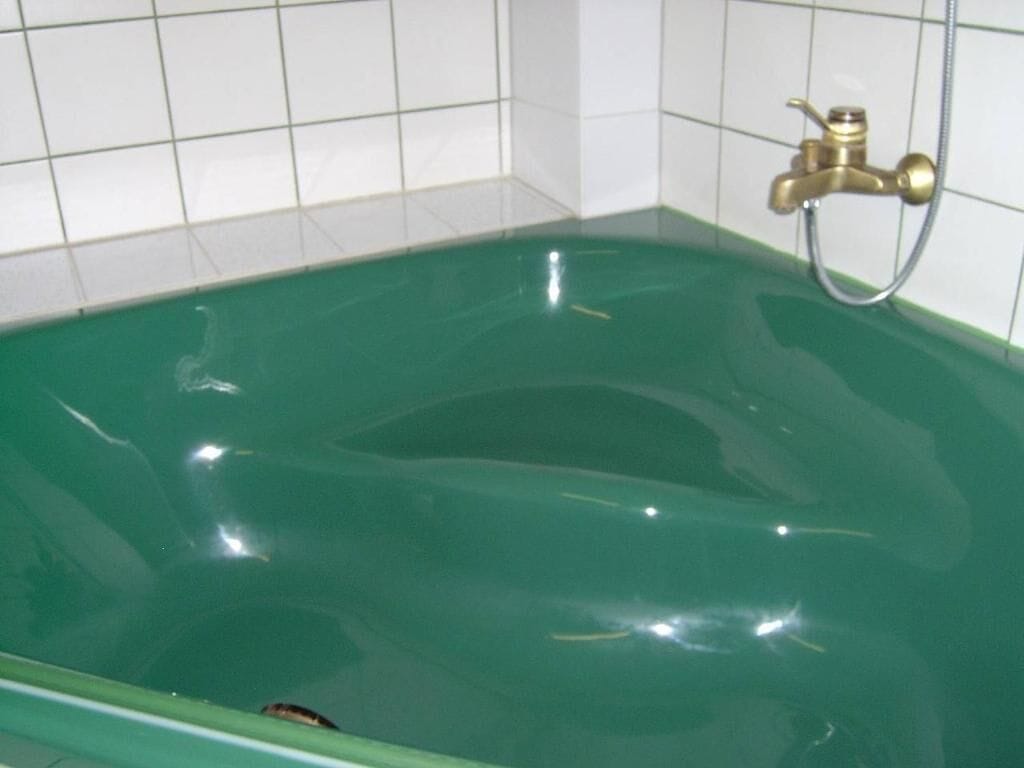 A bathtub with a faucet and a showerhead.