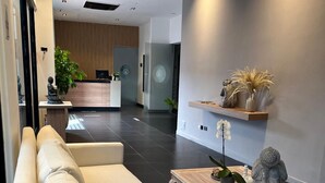 A modern living room with a sofa, a coffee table, and decorative items.