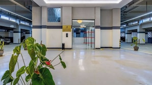A modern indoor parking garage with a clean, minimalist design, featuring a central entrance with glass doors and a ceiling light fixture. - Nairobi City -kilimani Next to Junction Mall (Nairobi)