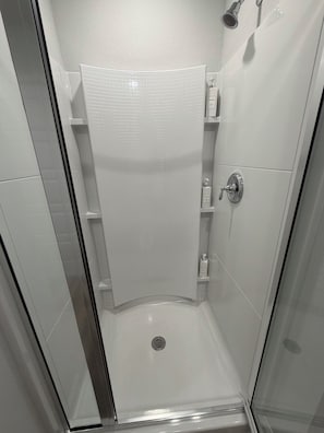 A shower with a glass door, a showerhead, and a control panel. - Townhouse:Central to Beach/Casino/Coliseum/Keesler (Biloxi)