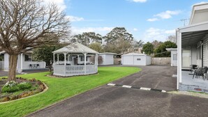 A caravan park with a gazebo, a covered outdoor seating area, and a building labeled 'Office.' - Phillip Island Cottages (Cowes)