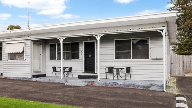 A single-story building with a porch, two windows, and a door. - Phillip Island Cottage 1 (Cowes)