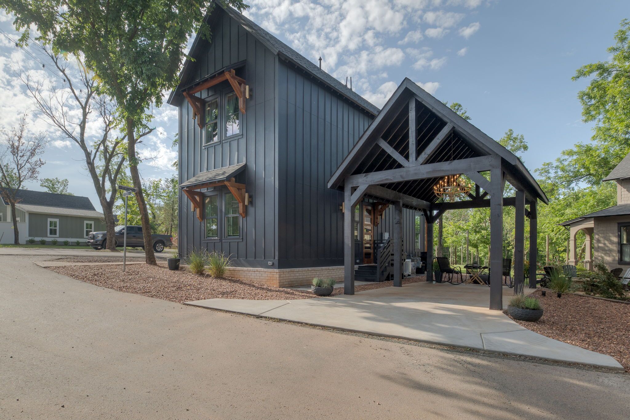 A two-story building with a covered porch and a garage.