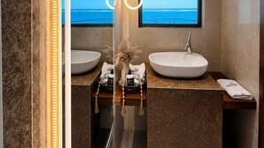 A modern bathroom with two sinks, a large mirror, and a view of the ocean. - Comforts Seaview Apartments-Nyali (Mombasa)