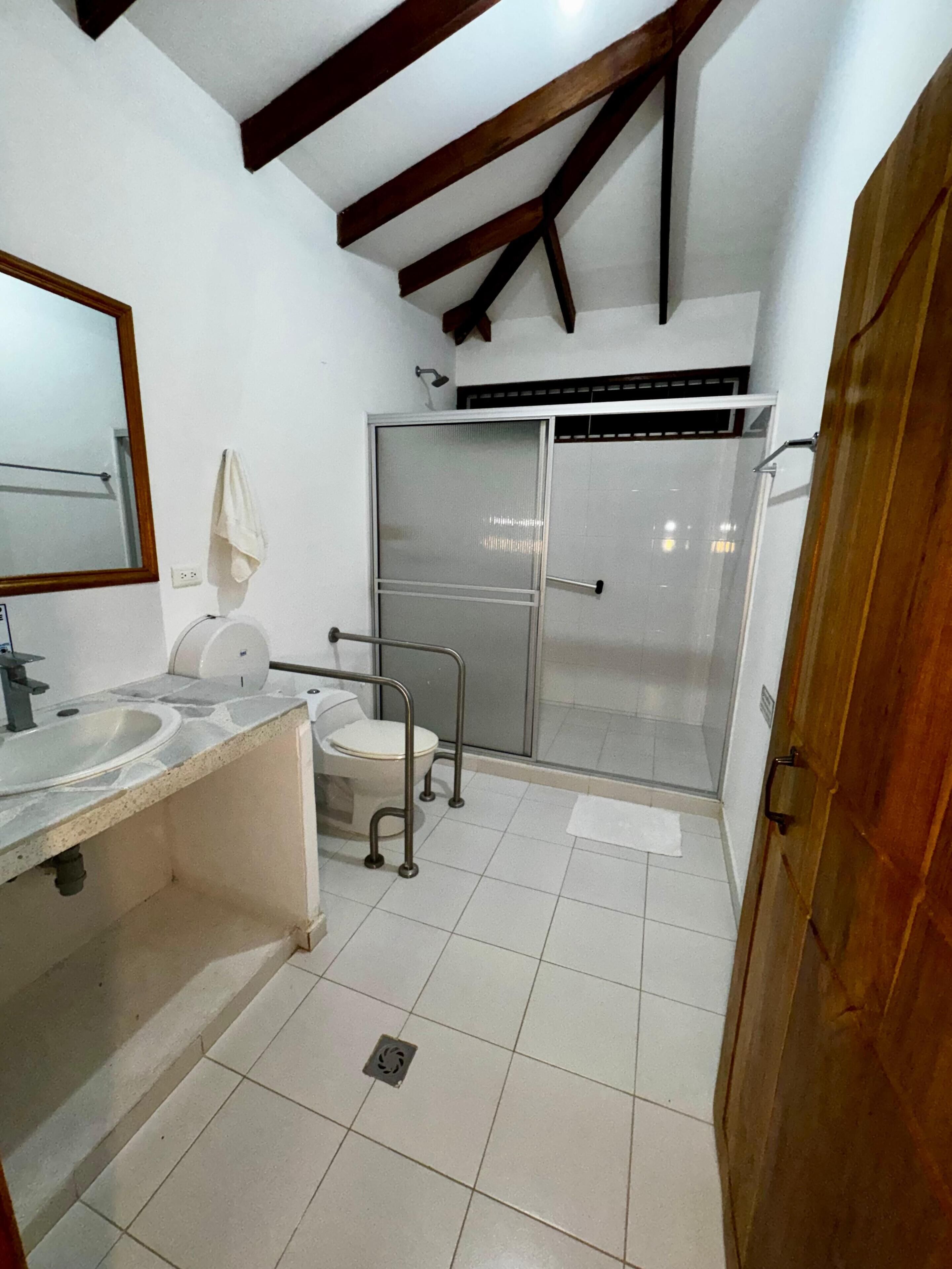 A bathroom with a sink, toilet, and shower.